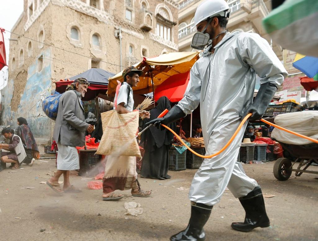 A health worker disinfects a market amid concerns of the spread of COVID-19, in Sana'a, Yemen 