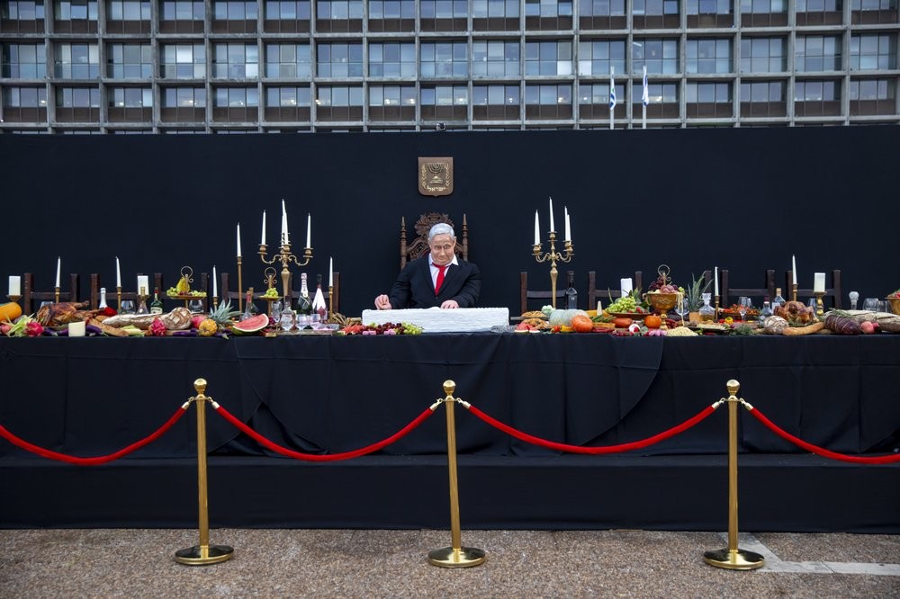 An installation depicting Prime Minister Benjamin Netanyahu at a mock "Last Supper" by Israeli artist Itay Zalait, is placed at Rabin square in Tel Aviv 