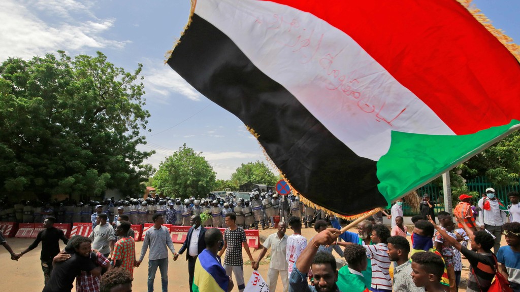Sudanese protesters march in a demonstration to mark the anniversary of a transitional power-sharing deal 