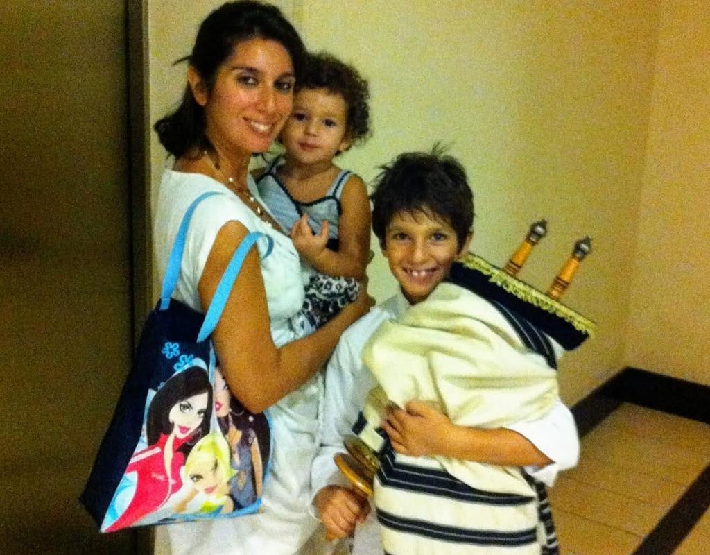 Ranna, Sara and Marco Arazi pose with the Torah donated to the community by London’s Marble Arch Synagogue (Photo: Courtesy) Ranna, Sara and Marco Arazi pose with the Torah donated to the community by London’s Marble Arch Synagogue