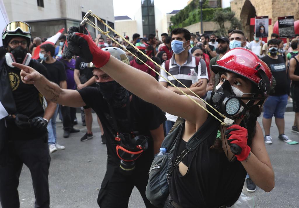 An anti-government protester uses a slingshot to launch a stone towards Lebanese riot police, during in Beirut, Sept. 1, 2020 (Photo: AP) An anti-government protester uses a slingshot to launch a stone towards Lebanese riot police, during in Beirut, Sept. 1, 2020