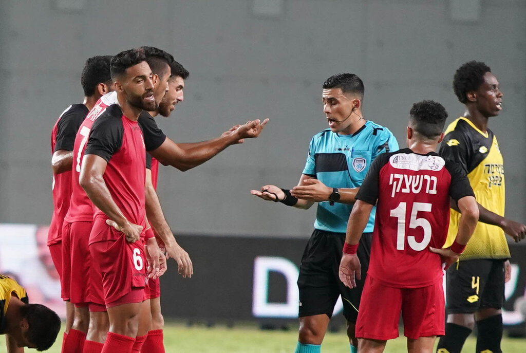Bnei Sakhnin arguing with a referee during a game (Photo: Reuven Schwartz) שחקני בני סכנין