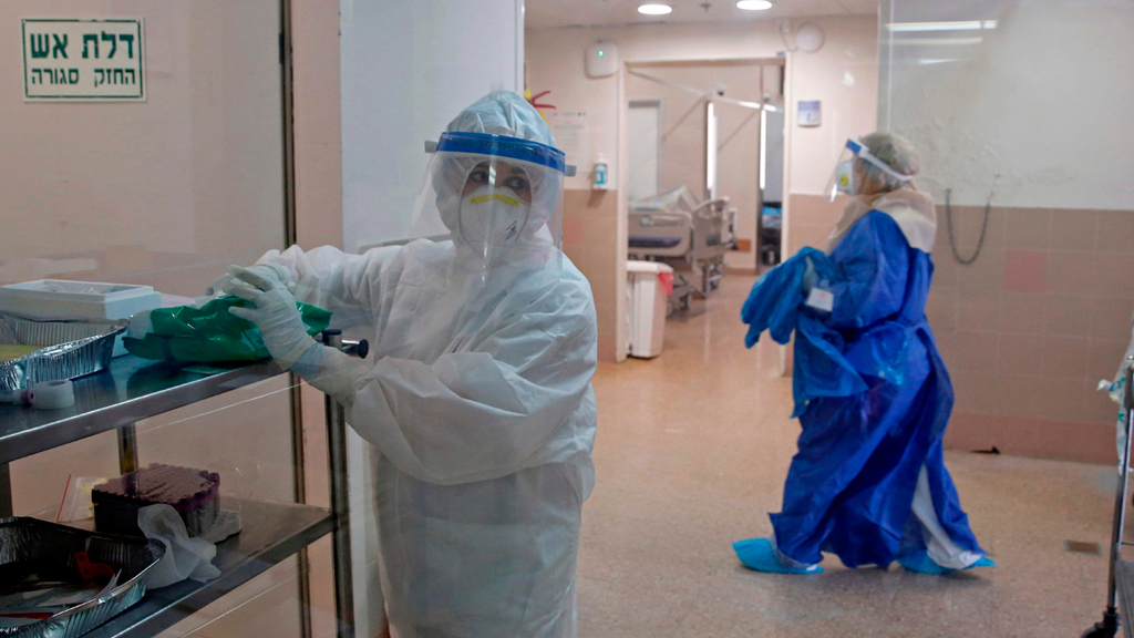 הצוות במחלקת הקורונה בסורוקה (צילום: AFP) הצוות הרפואי המחלקת הקורונה בסורוקה