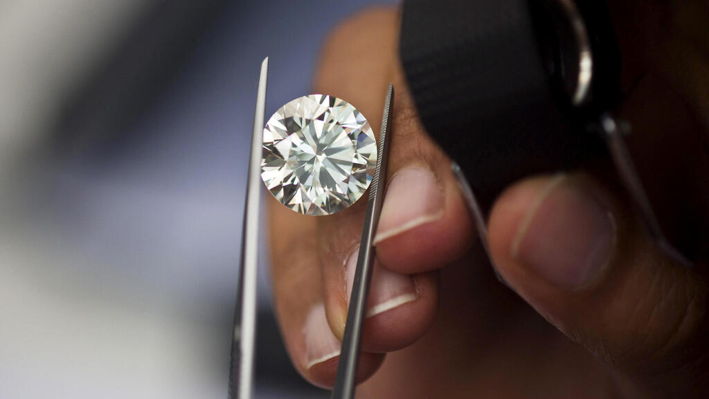 A trader inspects a diamond during a show at the trading floor of Israel's Diamond Exchange (IDE) in Ramat Gan near Tel Aviv,