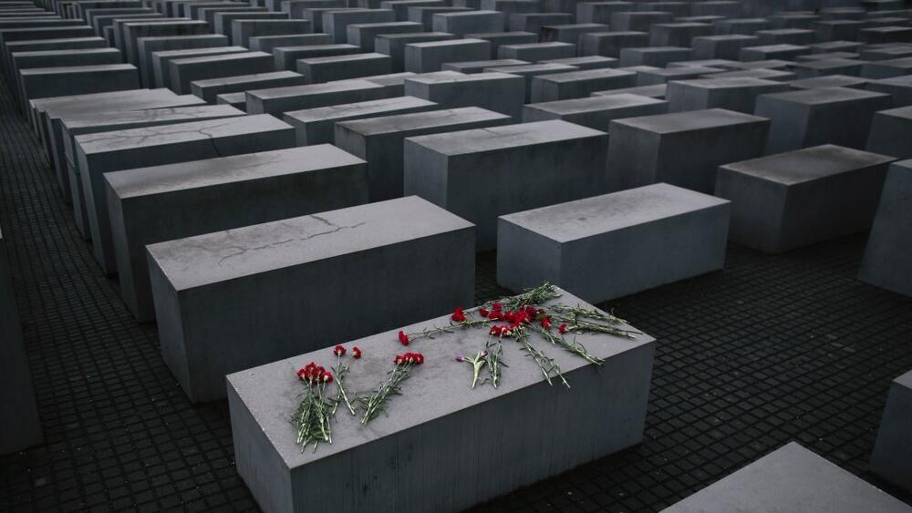  flowers lie on a concrete slab of the Holocaust Memorial to mark the International Holocaust Remembrance Day and commemorating the 70th anniversary of the liberation of the Nazi Auschwitz death camp in Berlin 