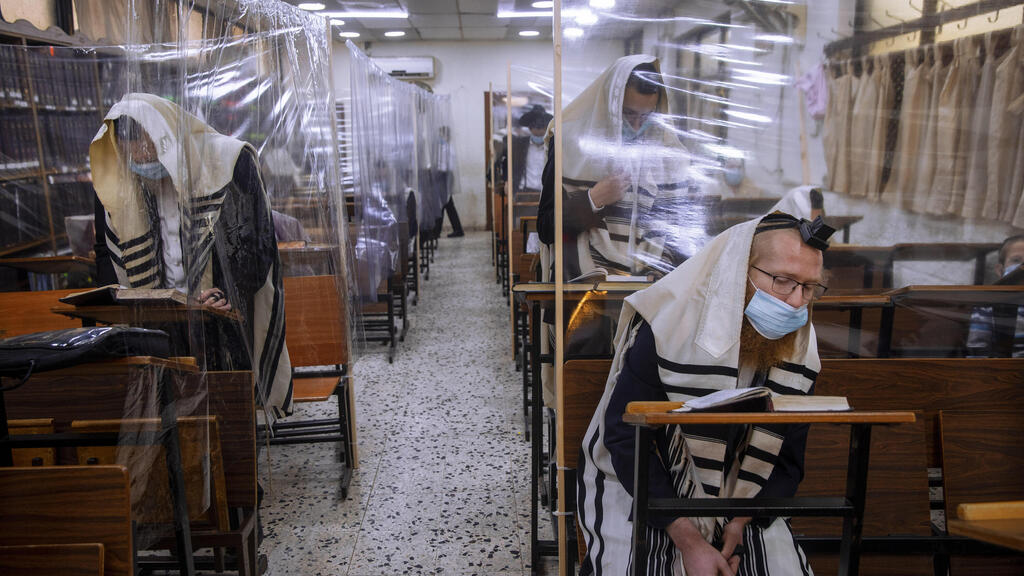 In this Monday, Sept 21, 2020 file photo, ultra-Orthodox Jews wear face masks during a morning prayer in a synagogue separated by plastic partitions, in Bnei Brak (Photo: AP) In this Monday, Sept 21, 2020 file photo, ultra-Orthodox Jews wear face masks during a morning prayer in a synagogue separated by plastic partitions, in Bnei Brak