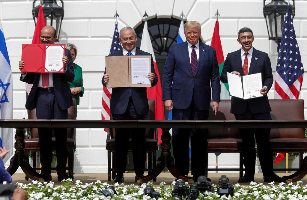 Bahrain’s Foreign Minister Abdullatif Al Zayani, Israel's Prime Minister Benjamin Netanyahu and United Arab Emirates (UAE) Foreign Minister Abdullah bin Zayed display their copies of signed agreements while U.S. President Donald Trump looks on as they participate in the signing ceremony of the Abraham Accords