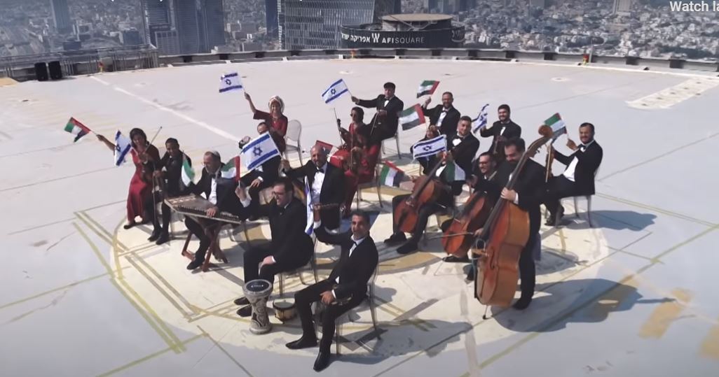 The Firqat Alnoor Orchestra waves israeli and Emirati flags as it performs a musical tribute to new bilateral ties 