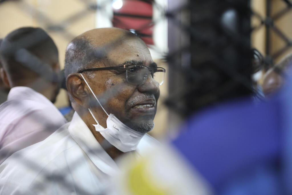 , Sudan's ousted president Omar al-Bashir sits at the defendant's cage during his trial a courthouse in Khartoum