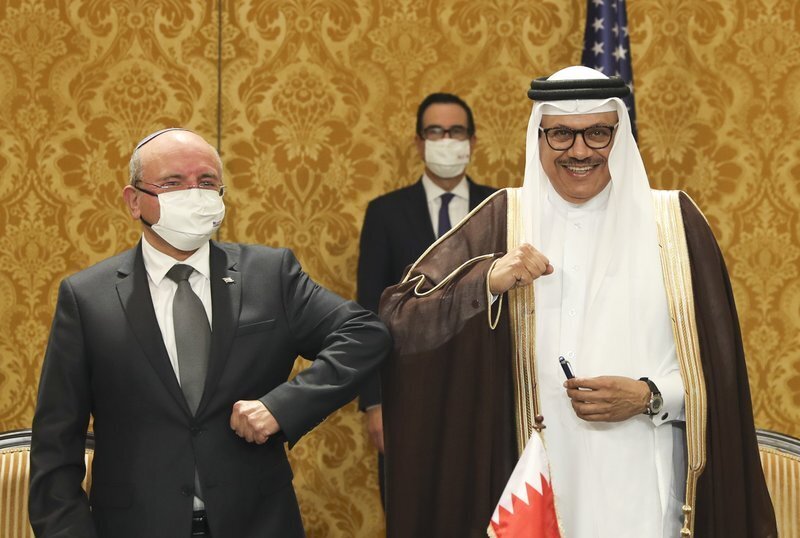 Israel's national security adviser, Meir Ben-Shabbat, left, bumps elbows with Bahrain's Foreign Minister Abdullatif al-Zayani after signing an agreement in Manama, Bahrain (Photo: AP) Israel's national security adviser, Meir Ben-Shabbat, left, bumps elbows with Bahrain's Foreign Minister Abdullatif al-Zayani after signing an agreement in Manama, Bahrain