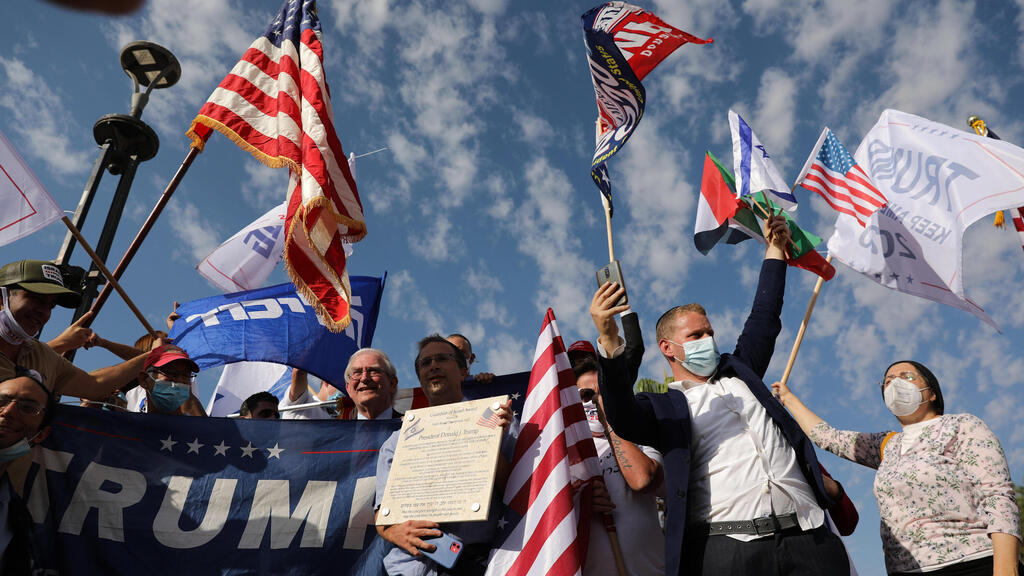 Israeli supporters of US President Donald Trump wave flags as they drive on a Highway on their way from Tel Aviv to Jerusalem, Israel, 27 October 2020 