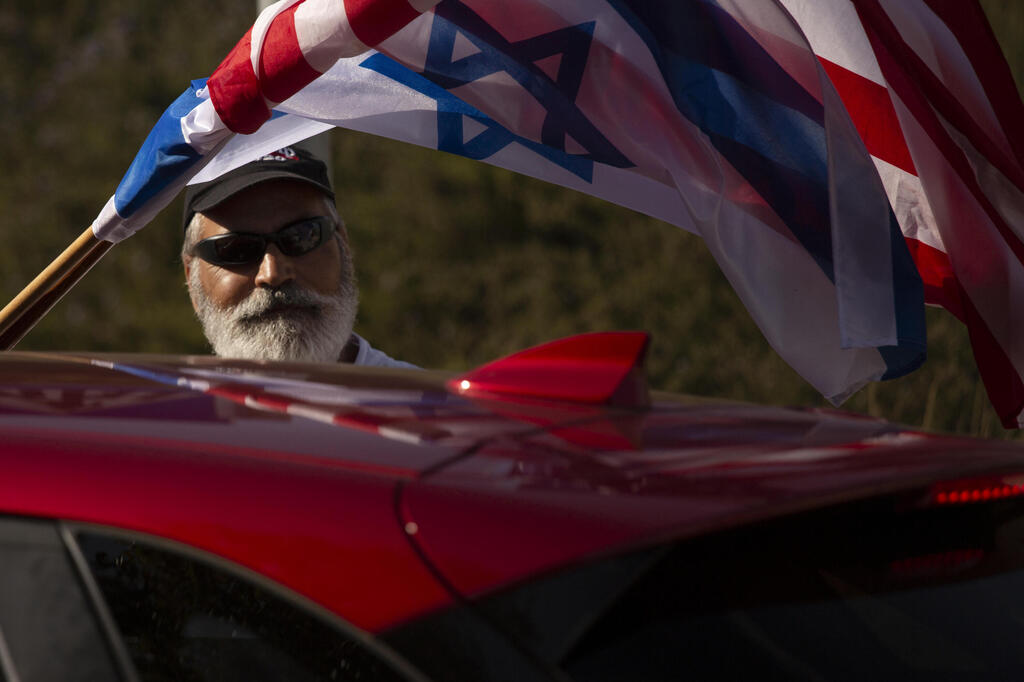 Israeli supporters of US President Donald Trump wave flags as they drive on a Highway on their way from Tel Aviv to Jerusalem, Israel, 27 October 2020 