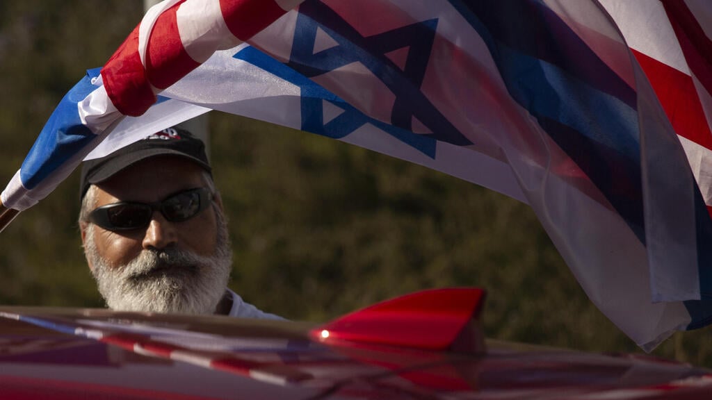 Israeli supporters of US President Donald Trump wave flags as they drive on a Highway on their way from Tel Aviv to Jerusalem, Israel, 27 October 2020 