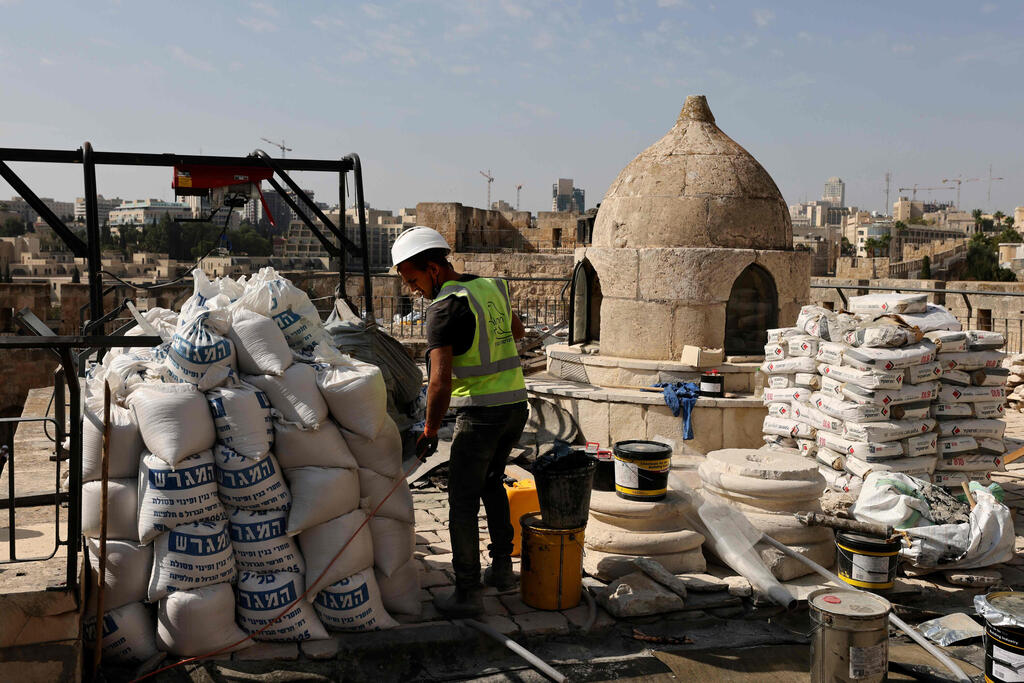 Workers renovate the Tower of David Museum in the ancient citadel of Jerusalem near the Jaffa Gate entrance to Jerusalem's Old City on October 28, 2020 