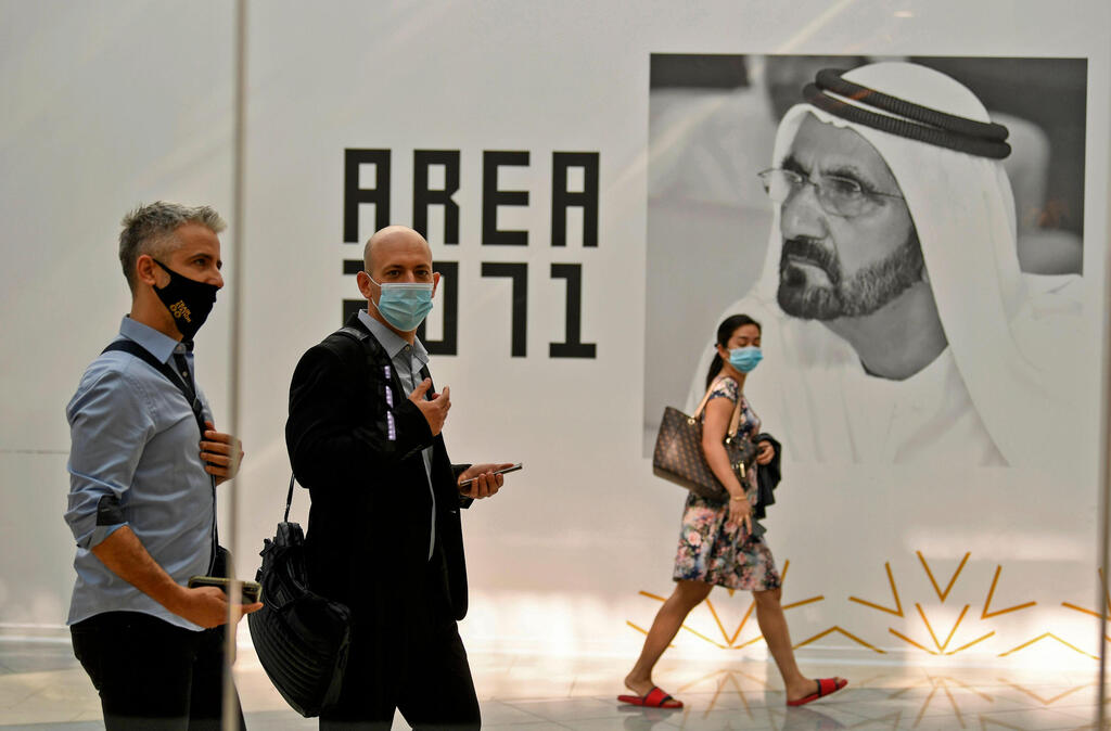 Members of Israeli high-tech delegation walk past a poster of Dubai's ruler Sheikh Mohammed bin Rashid al-Maktoum during a meeting with Emirati counterparts at the headquarters of the Government Accelerators in Dubai 