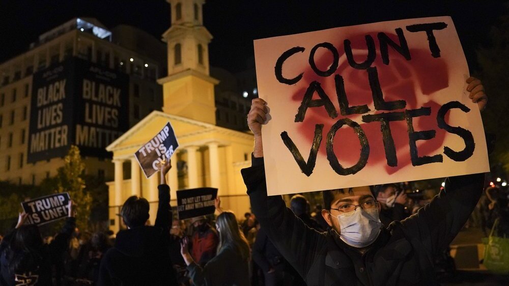 A demonstrator holds up a sign while waiting for results at Black Lives Matter Plaza, in Washington, D.C. on election night (Photo: AP) A demonstrator holds up a sign while waiting for election results at Black Lives Matter Plaza, Tuesday, Nov. 3, 2020, in Washington.