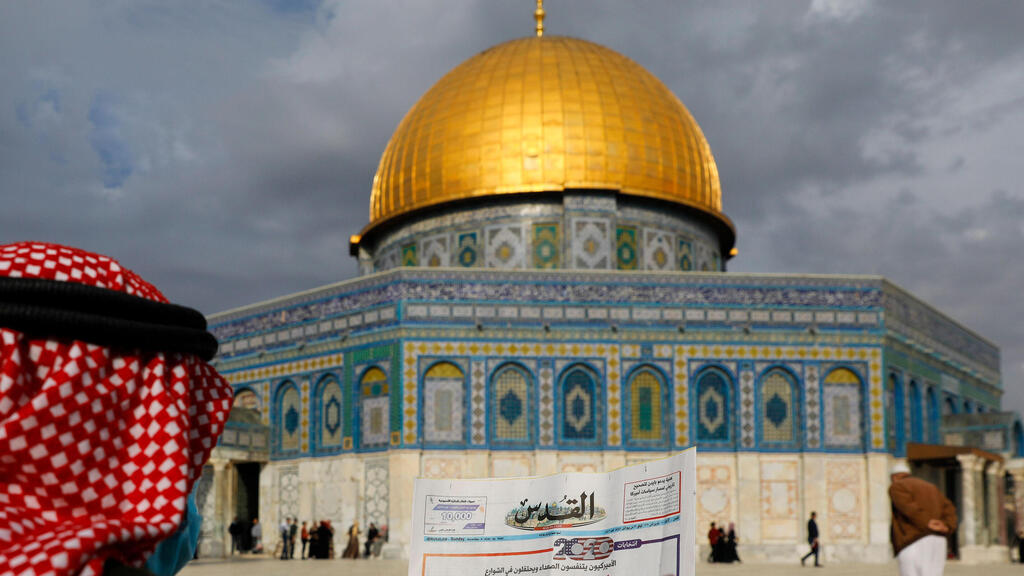 The Dome of the Rock in the al-Aqsa mosque compound (Photo: AFP) A Palestinian man reads the front page of Al-Quds newspaper, headlined in Arabic "Joe Biden the new US President" in front of the Dome of the Rock in the al-Aqsa mosque compound
