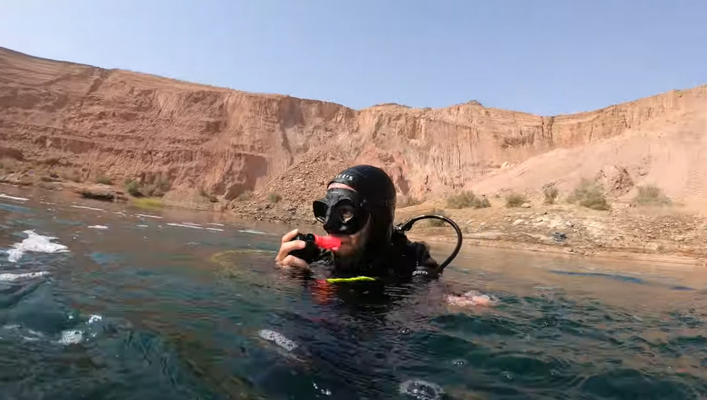 A diver in the secret lake in the Arava Desert 