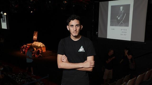 אסיף על רקע ארונו של זך, באולם צוותא. ''כשלא הייתה לו מוזה, הוא היה עצוב''