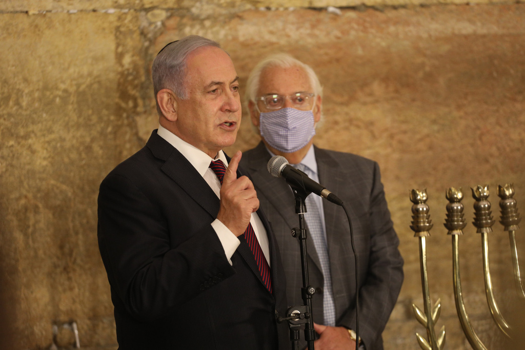 Prime Minister Benjamin Netanyahu at Hanukkah candle-lighting ceremony in Jerusalem; in background, U.S. Ambassador to Israel David Friedman (Photo: Emille Selman) בנימין נתניהו דייויד פרידמן הדלקת נרות חנוכה