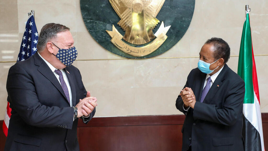 Sudan's Prime Ministers office on August 25, 2020, US Secretary of State Mike Pompeo (L) greets Sudanese Prime Minister Abdalla Hamdok (R) in Khartoum 