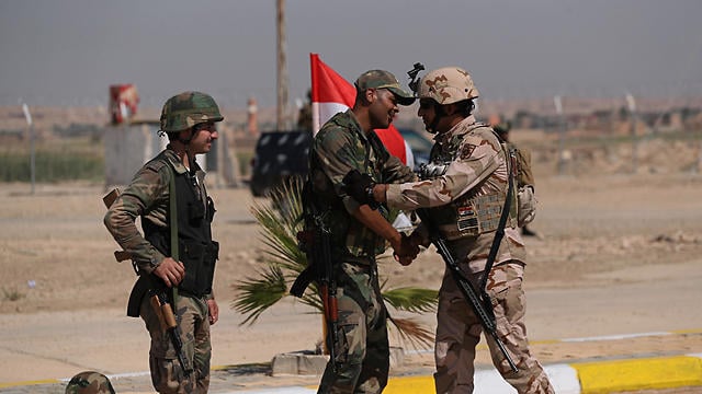 Iraqi and Syrian border troops celebrate the opening of a new crossing between the two states in 2019 (Photo: Archive) Iraqi and Syrian border troops celebrate the opening of a new crossing between the two states in 2019
