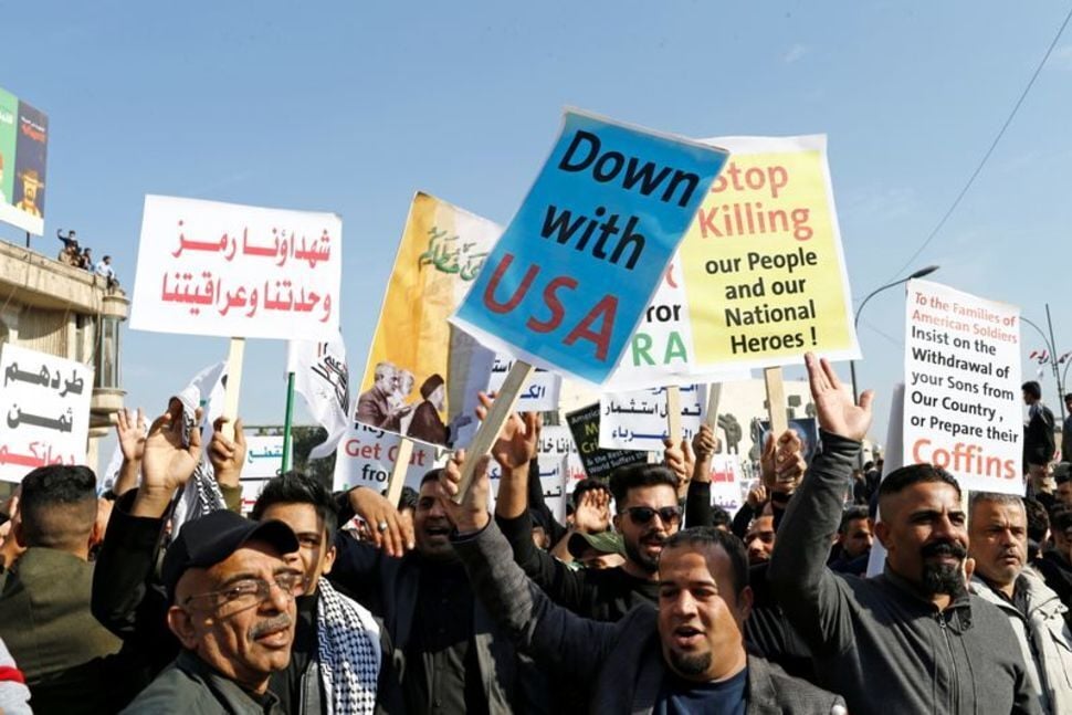 Iraqis, including supporters of Hashid Shaabi (Popular Mobilization Forces), gather during the one year anniversary of the killing of Qassem Soleimani Abu Mahdi al-Muhandis (Photo: AP) Iraqis, including supporters of Hashid Shaabi (Popular Mobilization Forces), hold placards as they gather to mark the one year anniversary of the killing of senior Iranian military commander General Qassem Soleimani and Iraqi militia commander Abu Mahdi al-Muhandis in a U.S. attack, in Baghdad, Iraq
