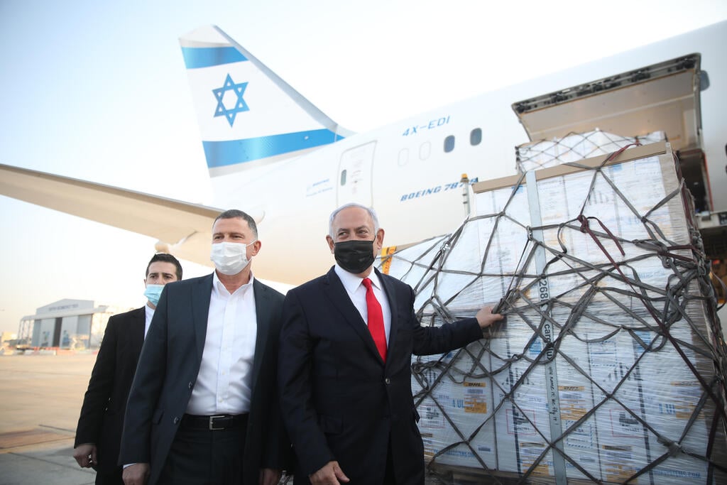 Health Minister Yuli Edelstein and Prime Minister Benjamin Netanyahu stand next to a shipment of Pfizer vaccines as they arrived at Ben-Gurion Airport, Jan. 2021 (Photo: GPO) Health Minister Yuli Edelstein and Prime Minister Benjamin Netanyahu stand next to a shipment of Pfizer vaccines as they arrived at Ben-Gurion Airport, Jan. 2021
