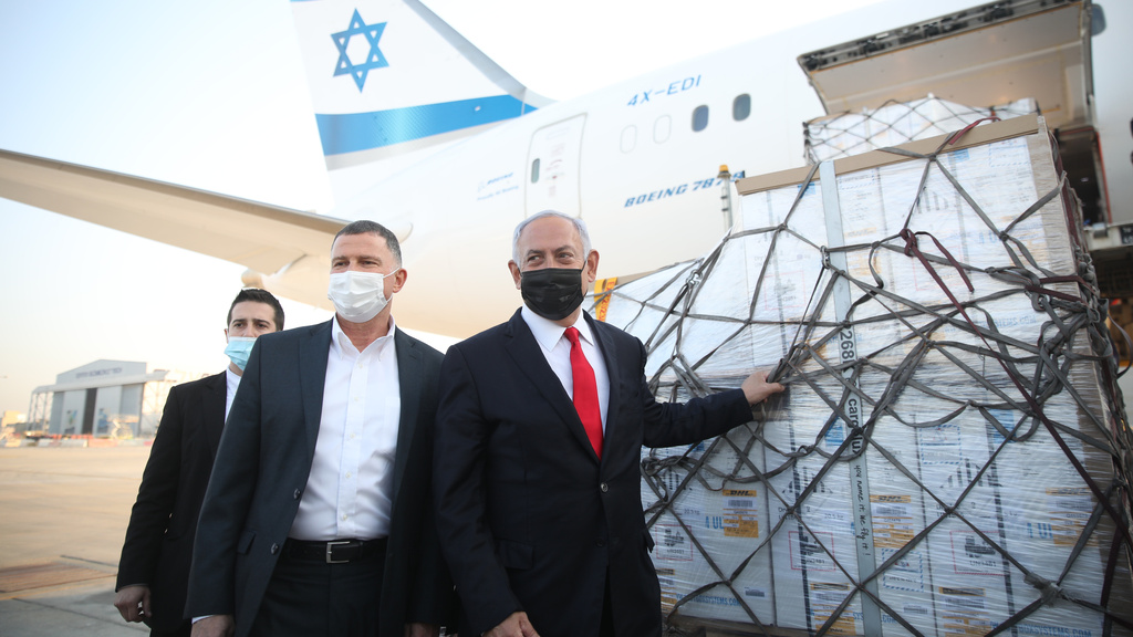 Health Minister Yuli Edelstein and Prime Minister Benjamin Netanyahu with a shipment of Pfizer's coronavirus vaccines 