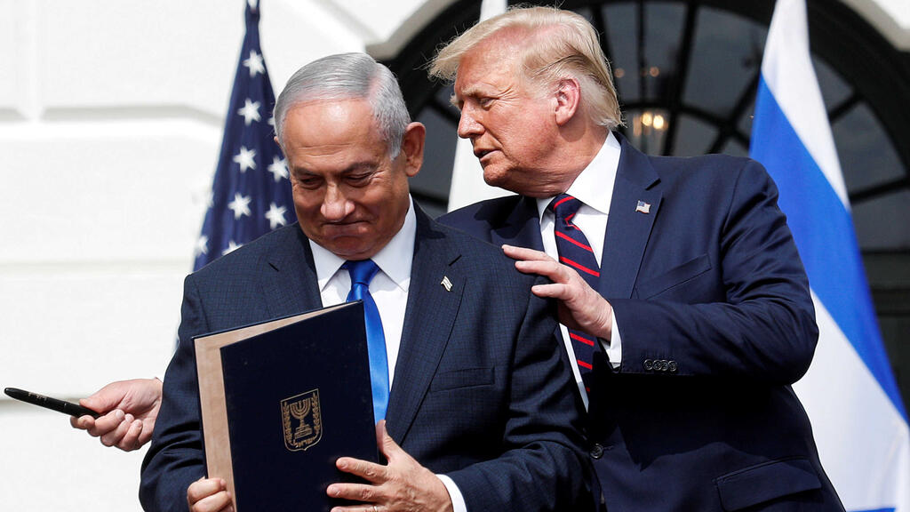 Prime Minister Benjamin Netanyahu stands with US President Donald Trump after signing the Abraham Accords, at the White House 