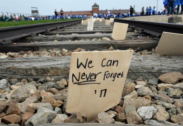 A sign is left on the tracks at the former Auschwitz-Birkenau death camp during the March of the Living in 2015 (Photo: AFP) A sign is seen on the tracks at the former Nazi German Auschwitz-Birkenau death camp during the 'March of the Living' in 2015