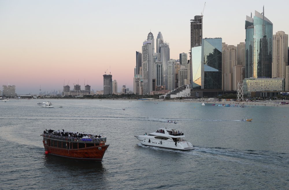 Tourists on a yacht as they pass a traditional dhow serving a dinner cruise, in Dubai, United Arab Emirates (Photo: AP) Tourists on a yacht as they pass a traditional dhow serving a dinner cruise, in Dubai, United Arab Emirates