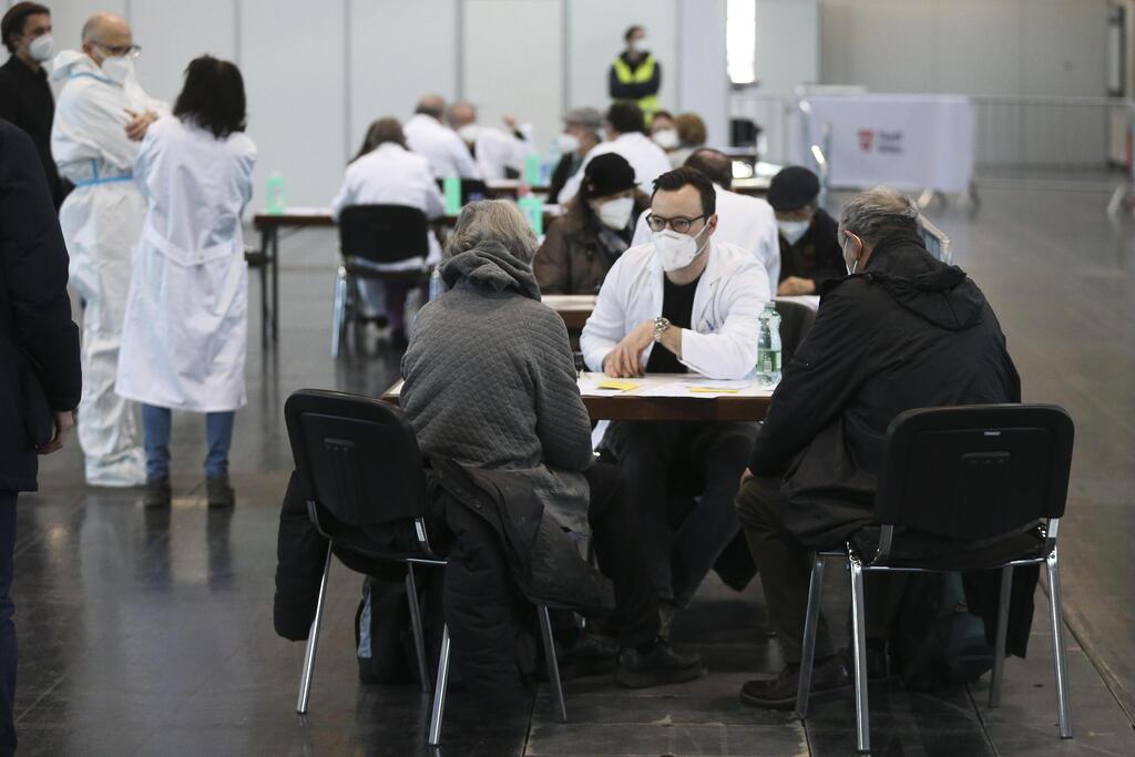 Two Holocaust survivors get information prior to their COVID-19 vaccine at a vaccination center on International Holocaust Remembrance Day in Vienna, Austria