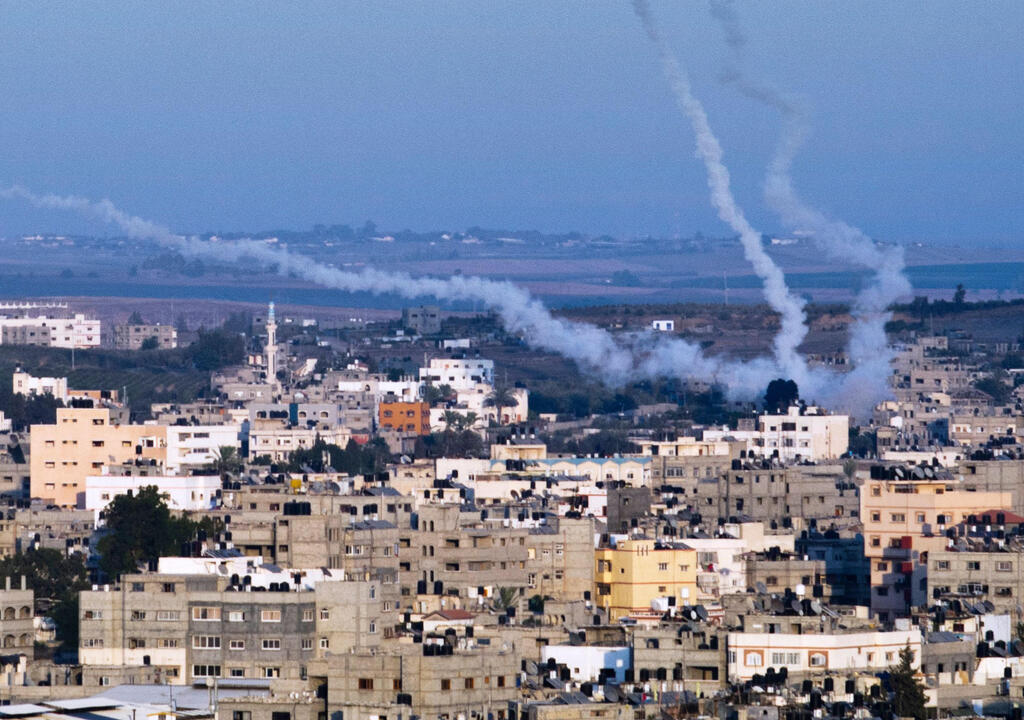 In this file photo taken on August 21, 2014 smoke trails mark the path of Palestinian missiles fired from the north-east of Gaza City 