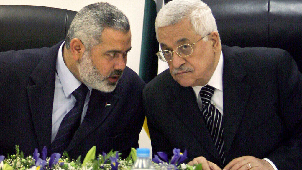 Palestinian Authority President Mahmoud Abbas, right, and then Palestinian Prime Minister Ismail Haniyeh of Hamas, left, 
