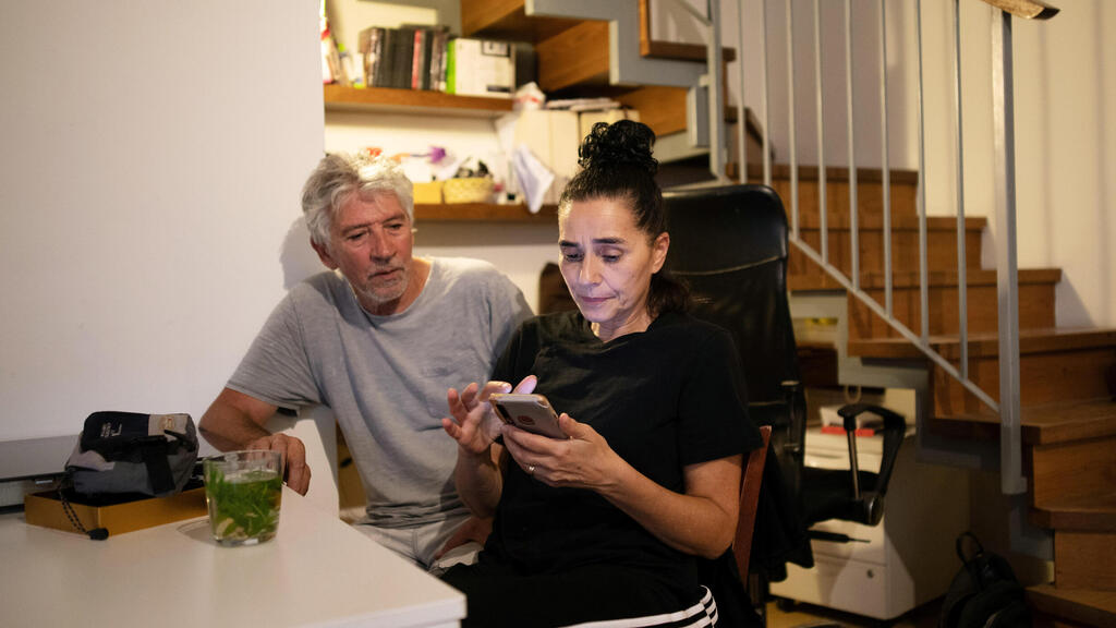 'Pink Front' member Sharon Saguy sits with her husband Roni Cohen at their Jerusalem home, Nov. 2020 
