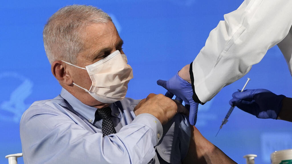 Dr. Anthony Fauci, director of the National Institute of Allergy and Infectious Diseases, prepares to receive his first dose of the COVID-19 vaccine 