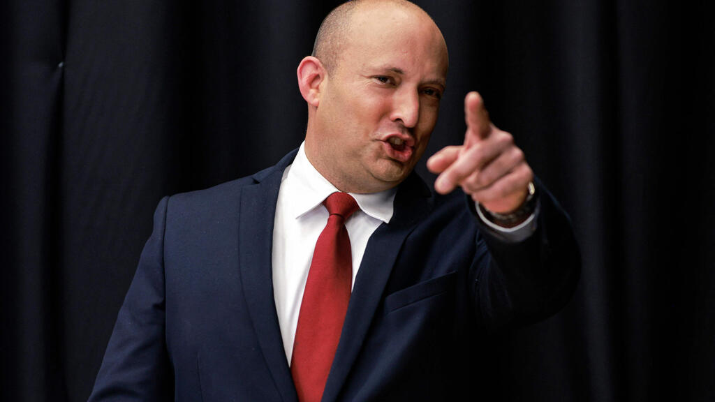 Naftali Bennett, leader of the Israeli right wing 'New Right' party, talks to reporters before speaking at a conference organised by the Besheva newspaper in Jerusalem on March 15, 2021 