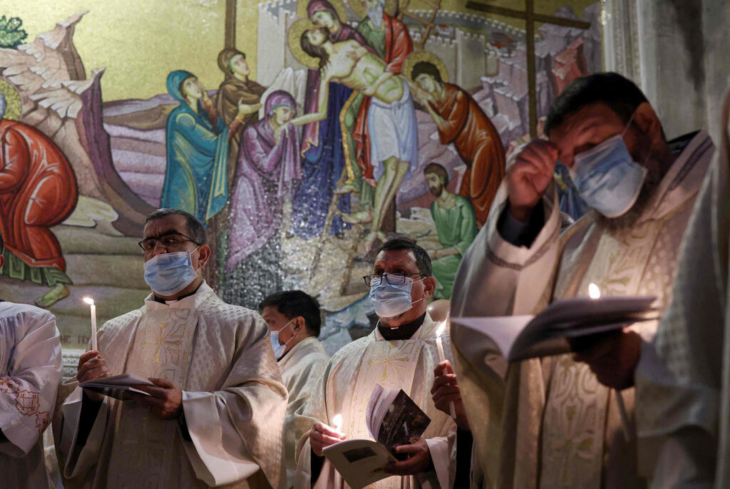 Fransiscan friars pray during mass on Easter Sunday at the Church of the Holy Sepulchre in Jerusalem, April 4, 2021 