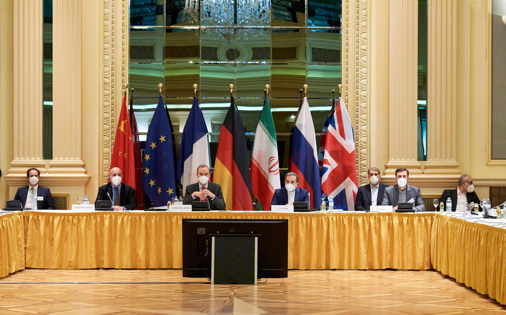 European External Action Service (EEAS) Deputy Secretary General Enrique Mora and Iranian Deputy at Ministry of Foreign Affairs Abbas Araghchi wait for the start of a meeting of the JCPOA Joint Commission in Vienna, Austria 