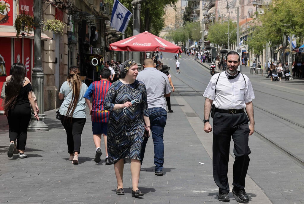 צילום: AFP בוטלה חובת עטיית המסכה בשטח פתוח