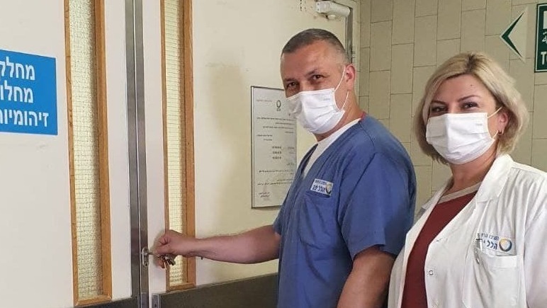 Nurse Alex Babet and Dr. Tatiana Michaelov close down lock the last remaining coronavirus ward at the Hillel Yaffe Medical Center in Hadera 