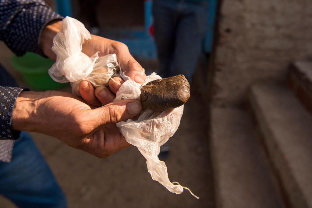 Farmer displays a piece of hashish near the town of Ketama in Morocco's northern Rif region, September 19, 2017 