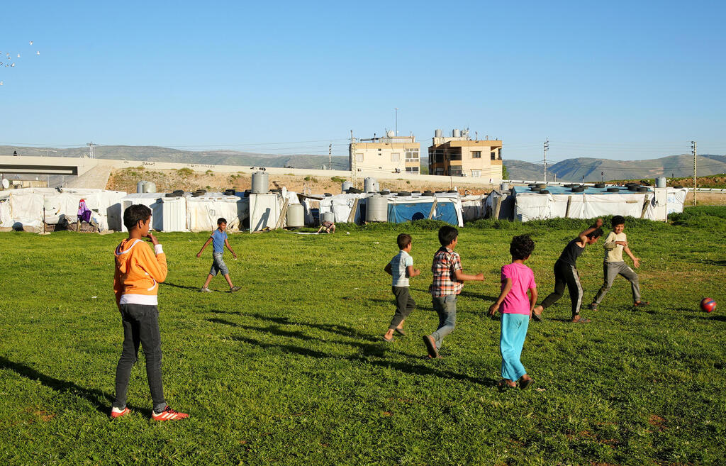 Syrian refugee youths play together at an informal tented settlement in Bar Elias, in the Bekaa Valley, Lebanon April 22, 2021