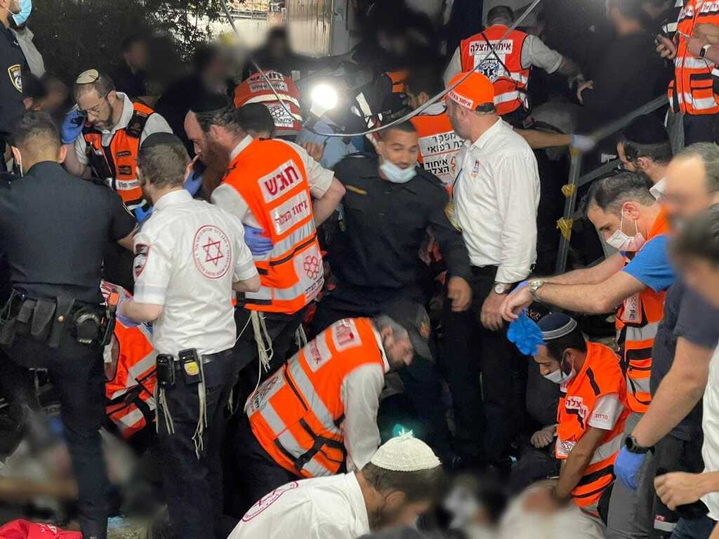 Rescue workers from the United Hatzalah volunteer service trying to reach the injured during the Meron disaster (Photo: United Hatzalah) Rescue workers from the United Hatzalah volunteer service trying to treat the injured during the Meron disaster