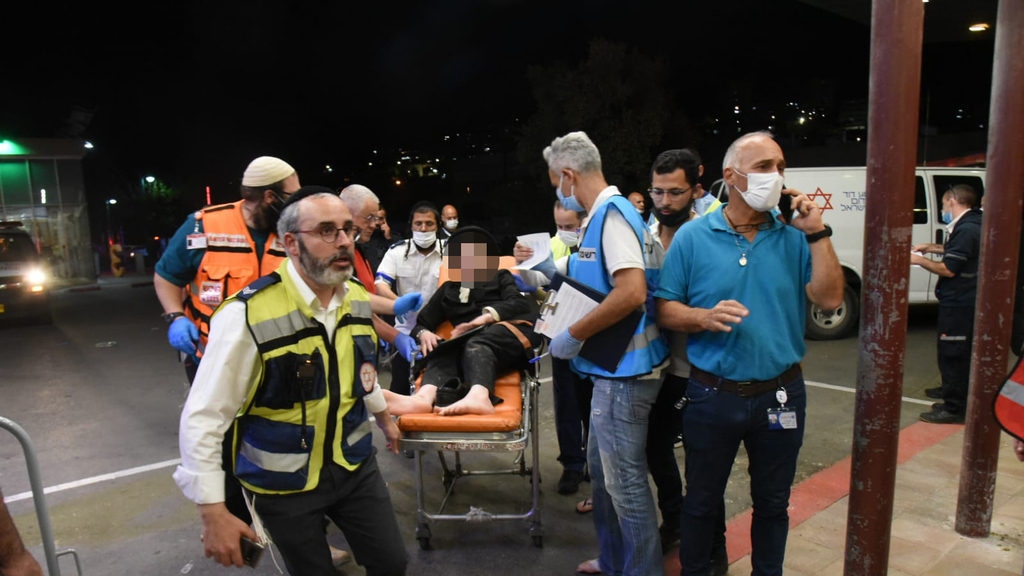   An injured man arrives at the Ziv Medical Center in Safed from the disaster at Mount Meron early on Friday 