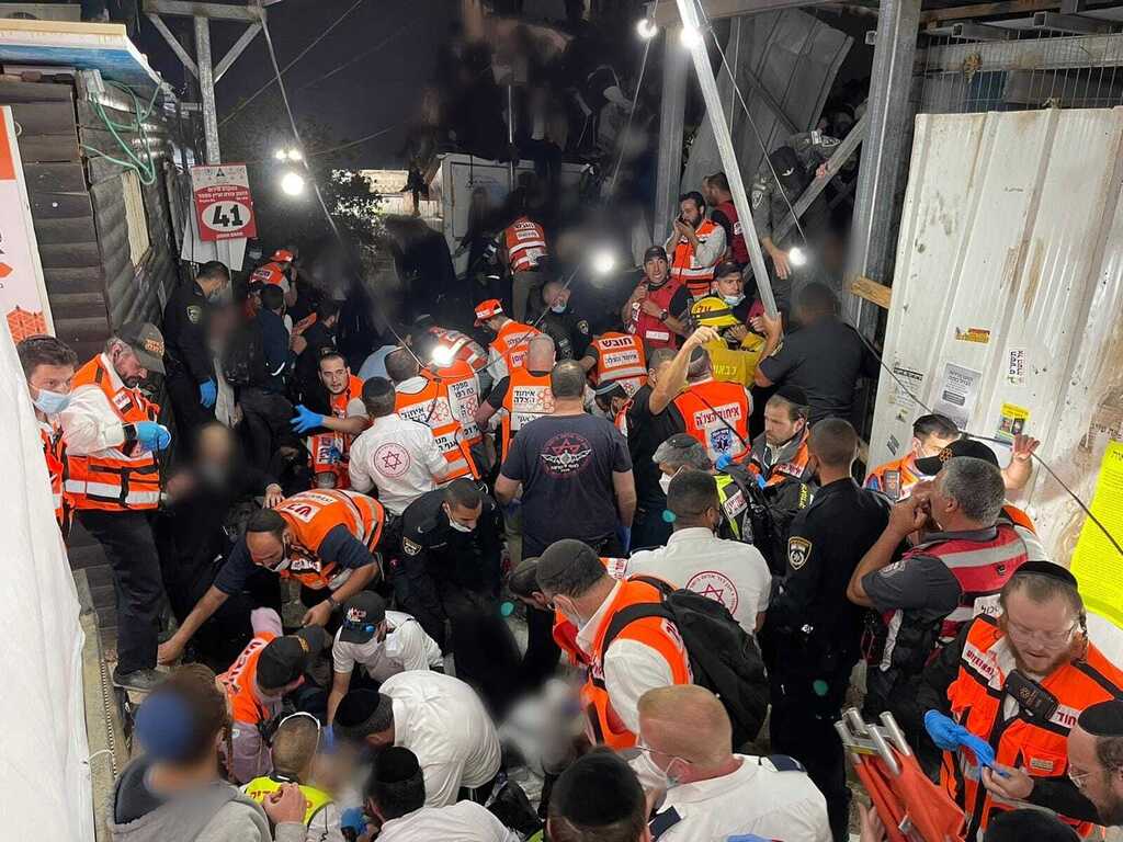 Rescue workers from the United Hatzalah volunteer service treating the injured during the Meron disaster (Photo: United Hatzalah) Rescue workers from the United Hatzalah volunteer service trying to treat the injured during the Meron disaster