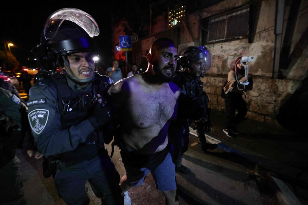 A Palestinian protester is arrested from in front of an Israeli settler's house during a demonstration as Palestinian families face eviction, part of an ongoing effort by Jewish Israelis to take control of homes in the Sheikh Jarrah neighbourhood of occupied east Jerusalem 