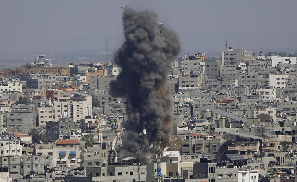 Smoke rises following Israeli airstrikes on a building in Gaza 