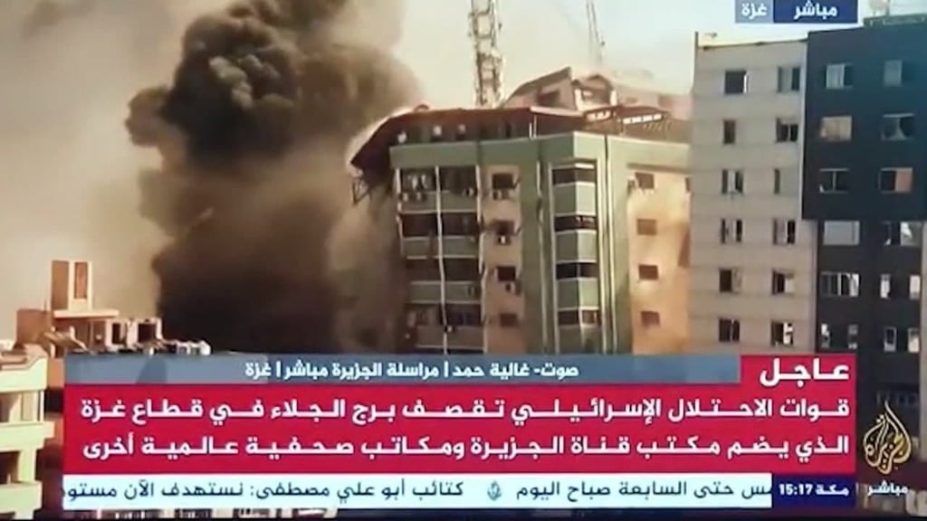 Al Jazeera reporting live as the building housing its offices collapses after being bombed in Gaza on Saturday תקיפות צה"ל בעזה: שיגור טיל הקש בגג אל עבר מגדל